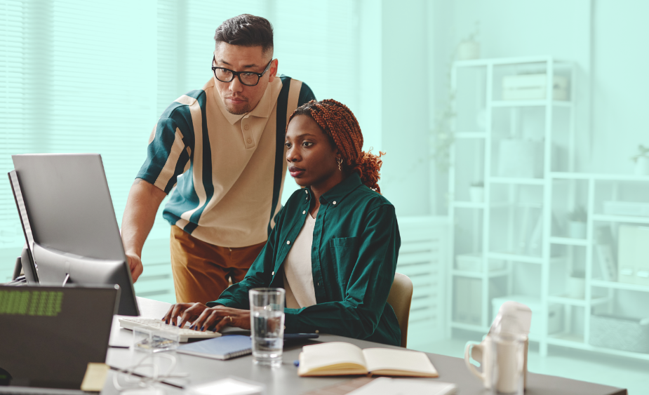 Two people working at a computer.